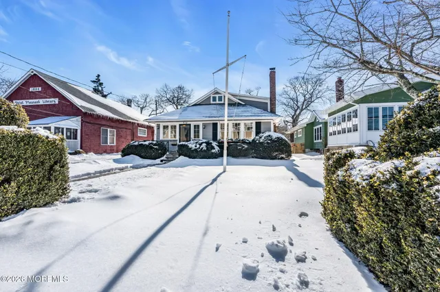a view of a house with a yard covered in snow