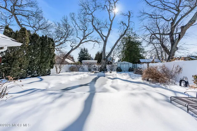 a view of a patio with table and chairs and potted plants
