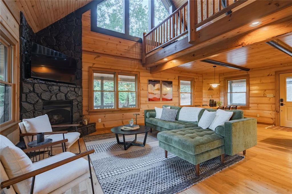a living room with furniture a flat screen tv and a fireplace
