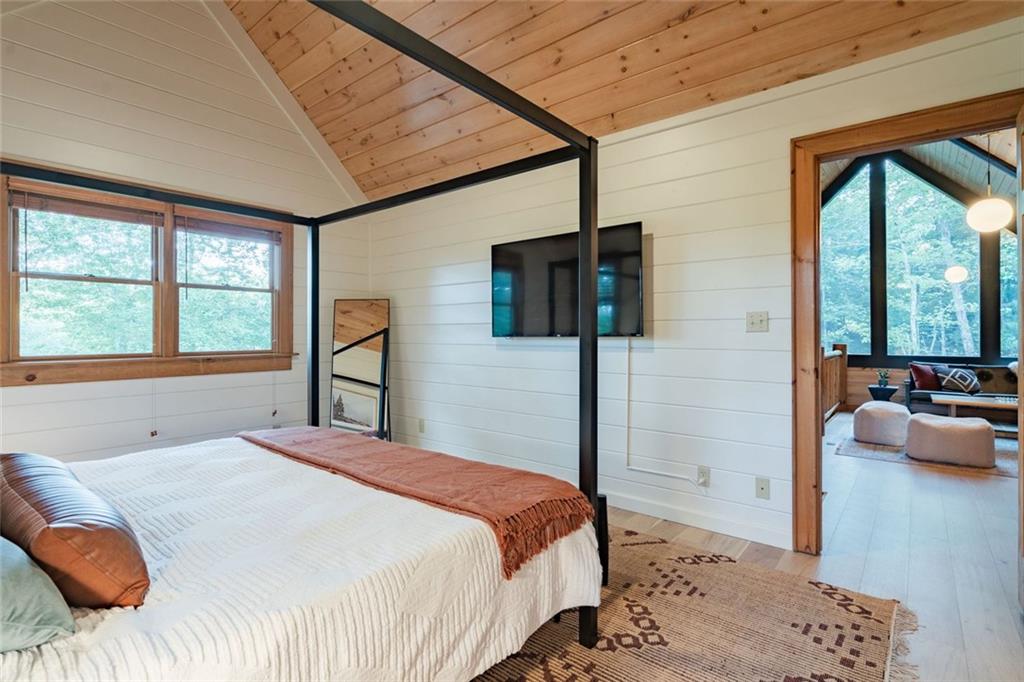 140 Black Oaks Road Cherry Log, GA 30522 - Photo 20 of 85 a bedroom with a large bed and a flat tv screen
