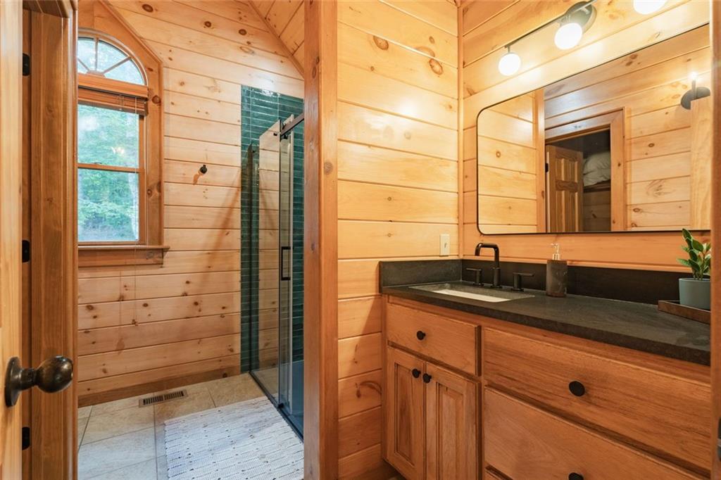 140 Black Oaks Road Cherry Log, GA 30522 - Photo 23 of 85 a bathroom with a granite countertop sink mirror and double