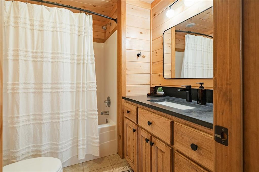 140 Black Oaks Road Cherry Log, GA 30522 - Photo 41 of 85 a bathroom with a granite countertop sink and a mirror