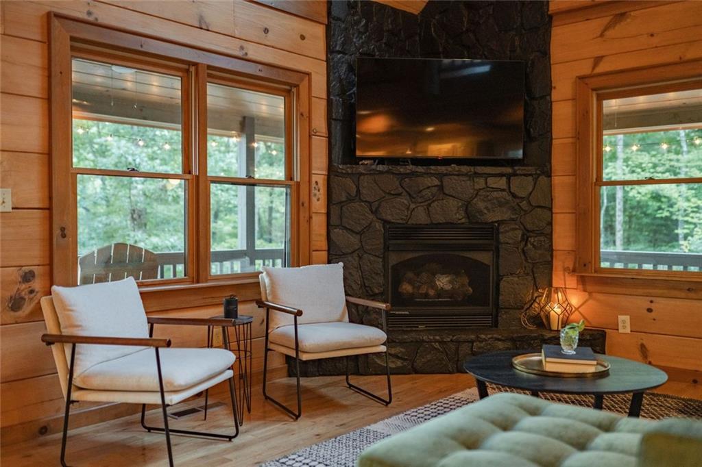 140 Black Oaks Road Cherry Log, GA 30522 - Photo 5 of 85 a living room with furniture a fireplace and a flat screen tv