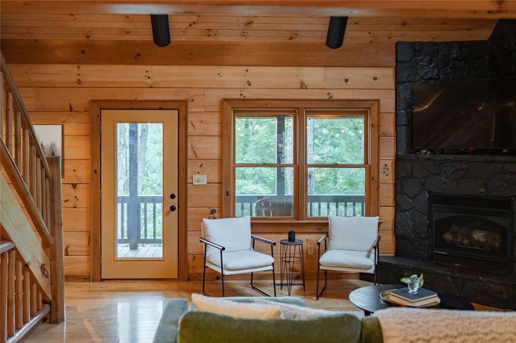 140 Black Oaks Road Cherry Log, GA 30522 - Photo 6 of 85 a living room with furniture a fireplace and a floor to ceiling window