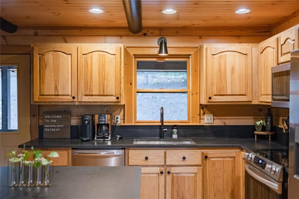 140 Black Oaks Road Cherry Log, GA 30522 - Photo 7 of 85 a kitchen with stainless steel appliances granite countertop a sink a stove and cabinets
