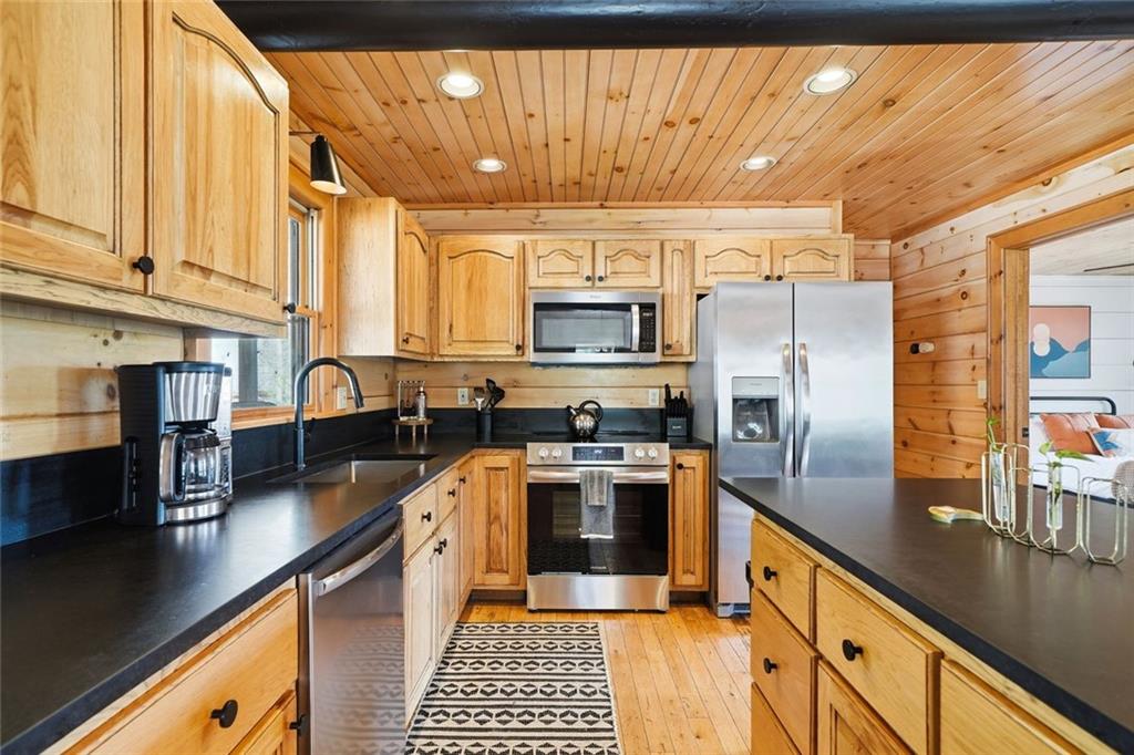 140 Black Oaks Road Cherry Log, GA 30522 - Photo 8 of 85 a kitchen with stainless steel appliances a sink a stove a refrigerator cabinets and a dining table