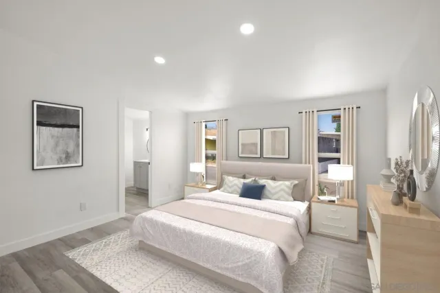 a bedroom with a large bed and a painting on the wall