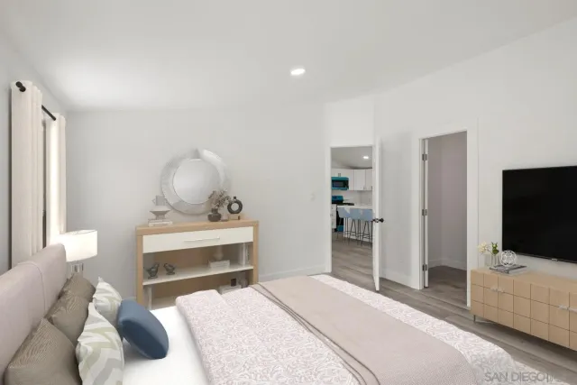 a bedroom with a bed and flat screen tv