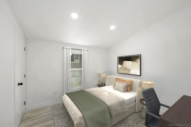 a bedroom with a bed and painting on the wall