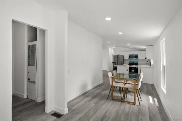 a dining room with furniture and wooden floor