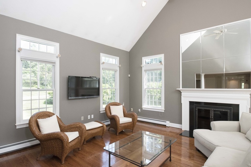 77 High Pines Drive Kingston, MA 02364 - Photo 11 of 28 a living room with furniture a fireplace and a flat screen tv