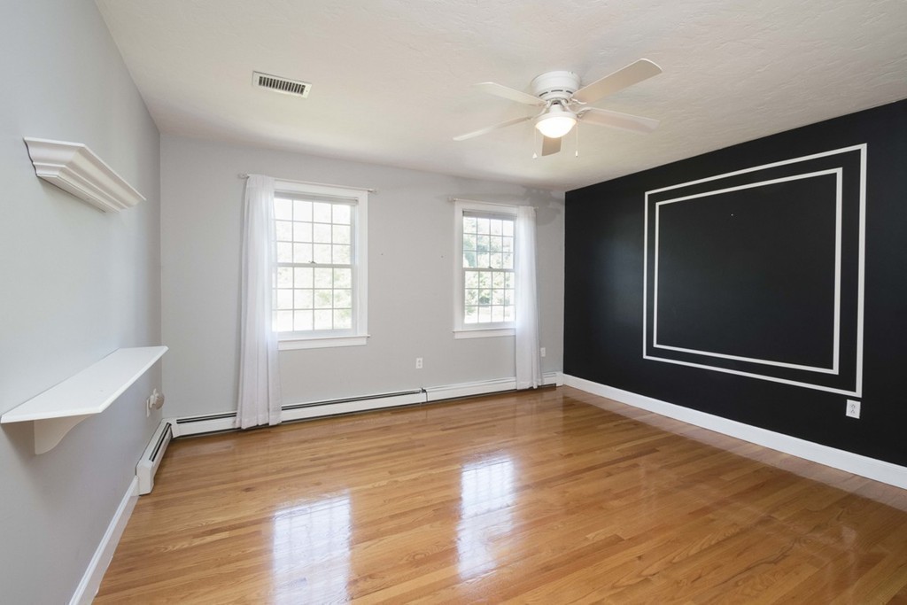 77 High Pines Drive Kingston, MA 02364 - Photo 19 of 28 a view of an empty room with window and wooden floor