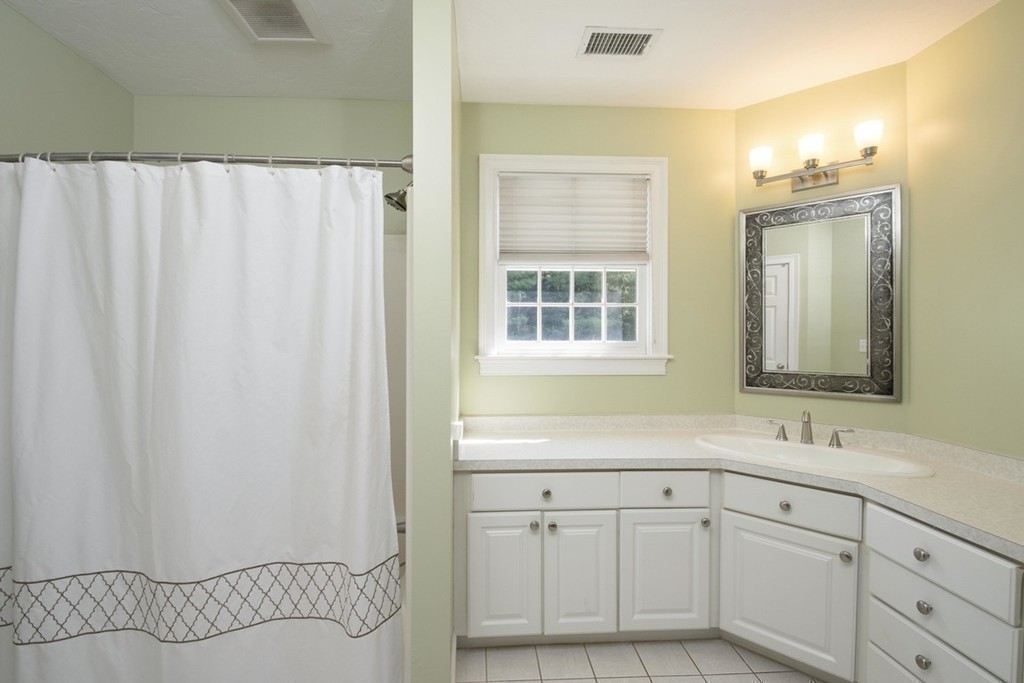 77 High Pines Drive Kingston, MA 02364 - Photo 20 of 28 a bathroom with a sink a mirror and a shower