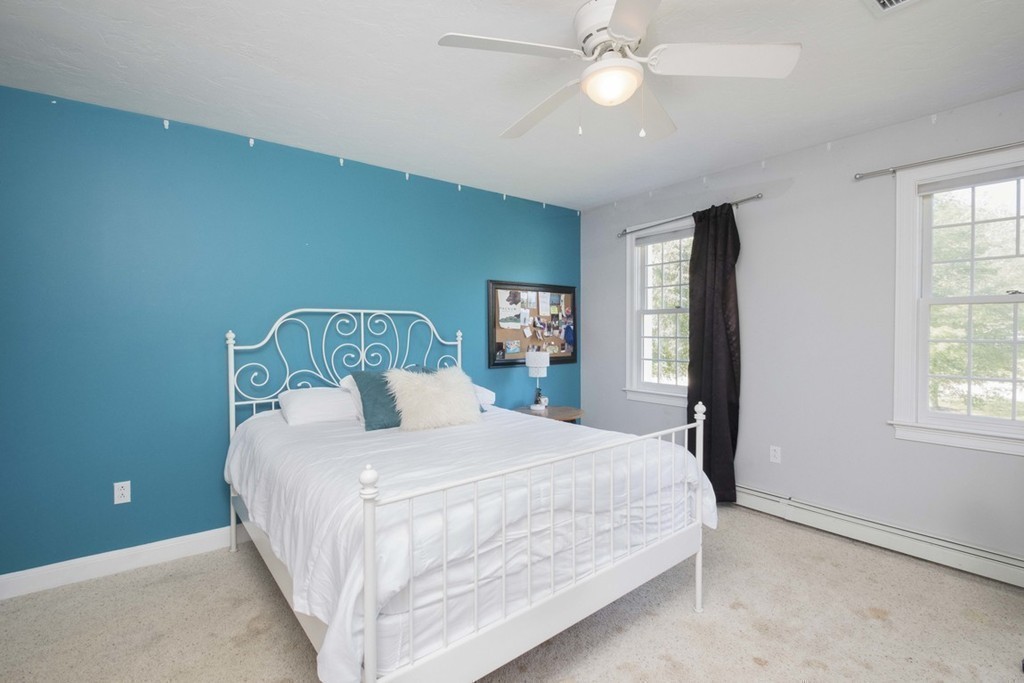 77 High Pines Drive Kingston, MA 02364 - Photo 22 of 28 a bedroom with a large bed and a chandelier