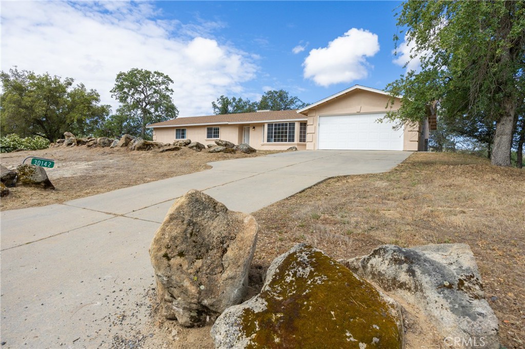 30142 Revis Road Coarsegold, CA 93614 - Photo 2 of 43 a front view of a house with a yard and garage