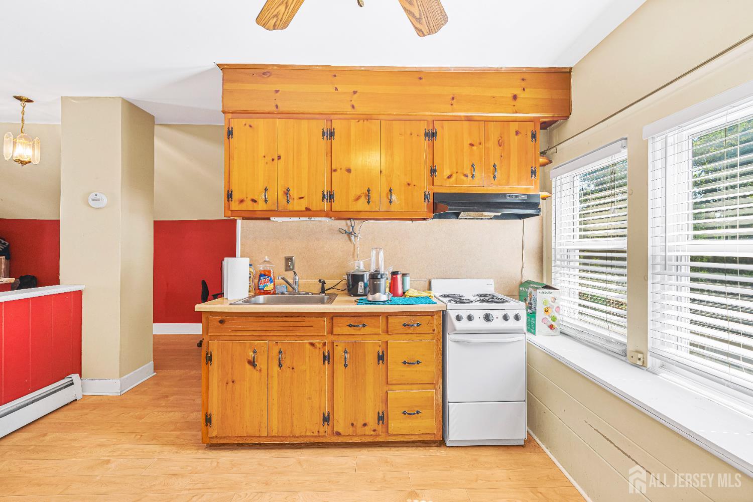 305 Penfield Place Dunellen, NJ 08812 - Photo 24 of 53 a kitchen with stainless steel appliances a stove a sink and a refrigerator