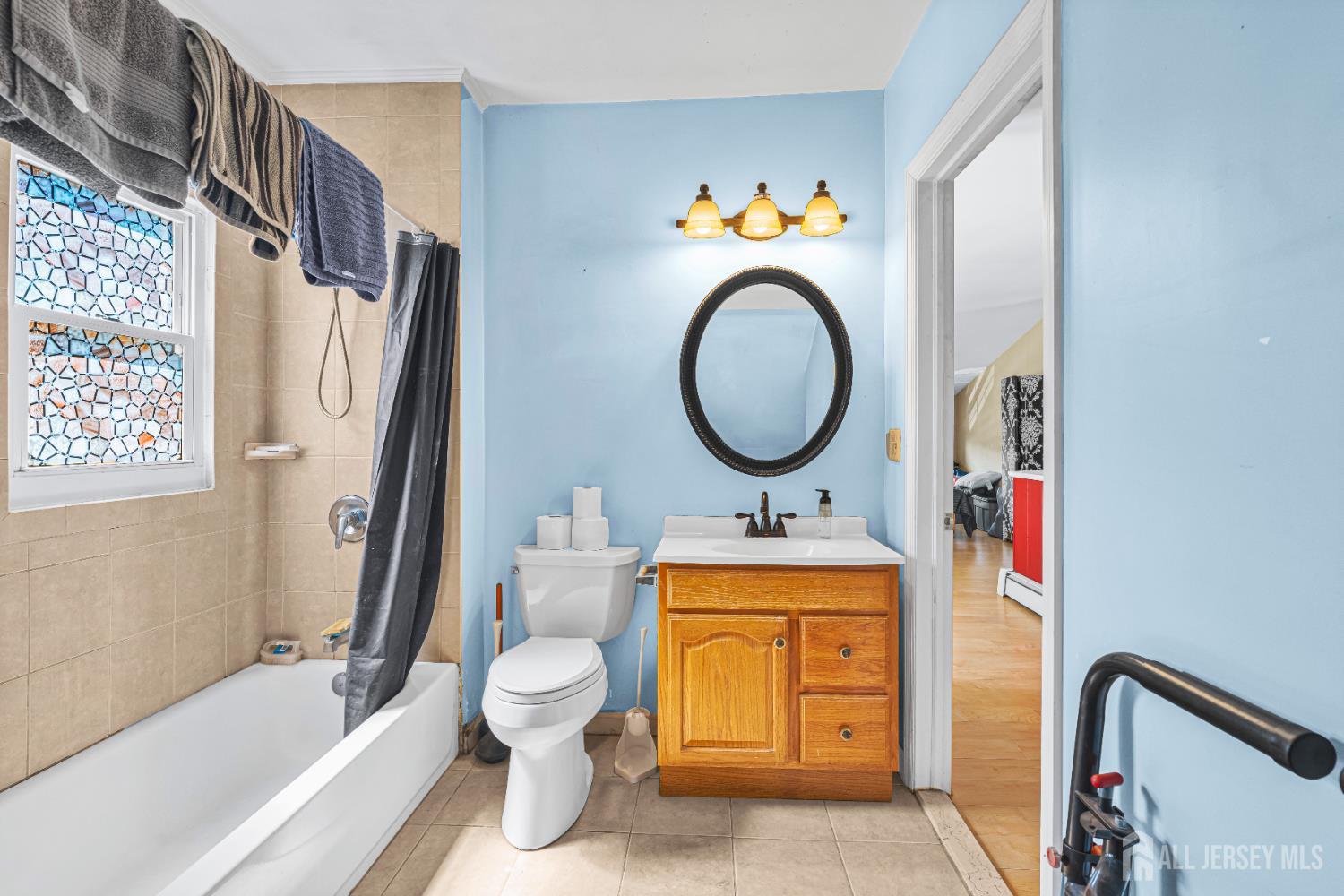 305 Penfield Place Dunellen, NJ 08812 - Photo 28 of 53 a bathroom with a toilet sink tub and mirror