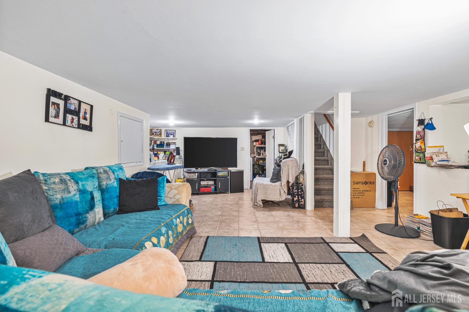305 Penfield Place Dunellen, NJ 08812 - Photo 30 of 53 a living room with furniture and a flat screen tv