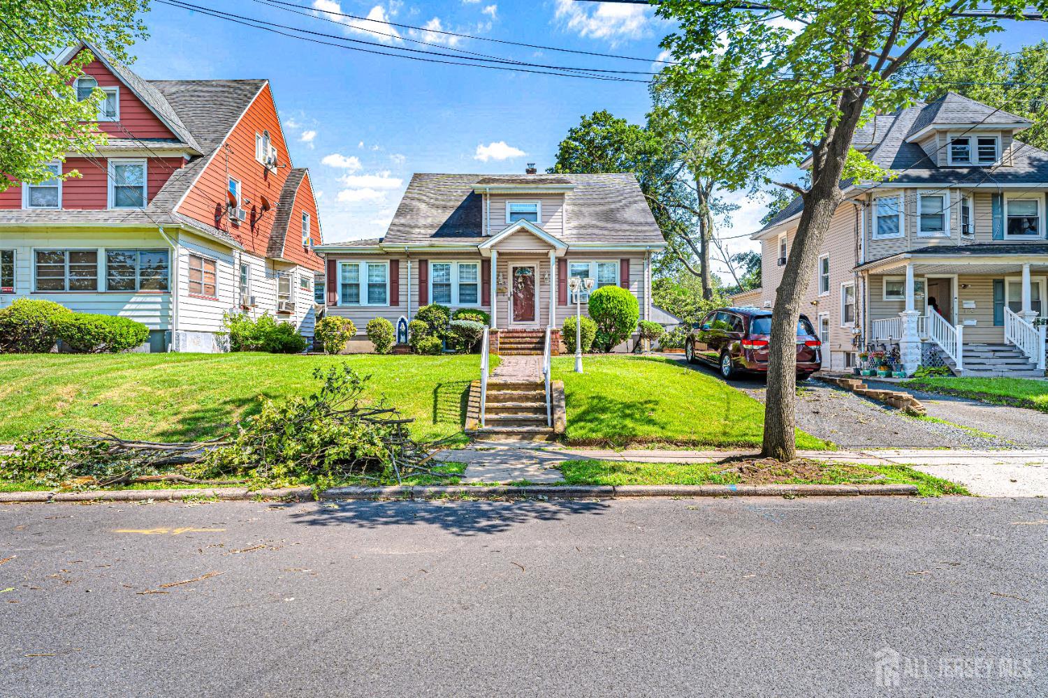 305 Penfield Place Dunellen, NJ 08812 - Photo 3 of 53 a front view of residential houses with yard and green space