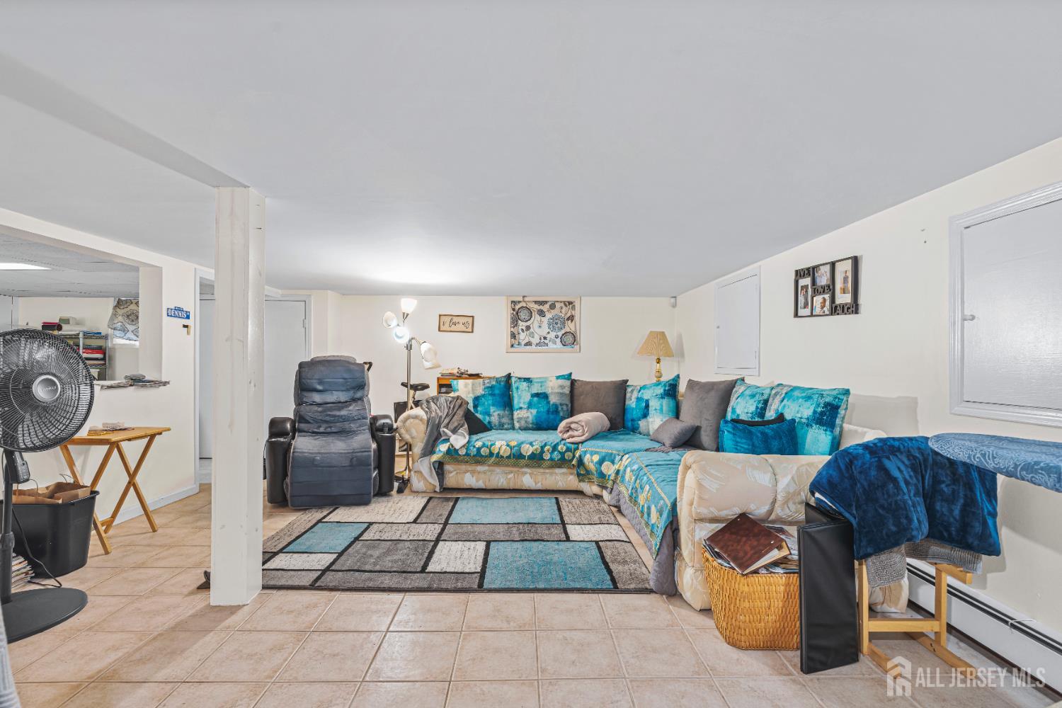 305 Penfield Place Dunellen, NJ 08812 - Photo 33 of 53 a living room with furniture a table and a potted plant