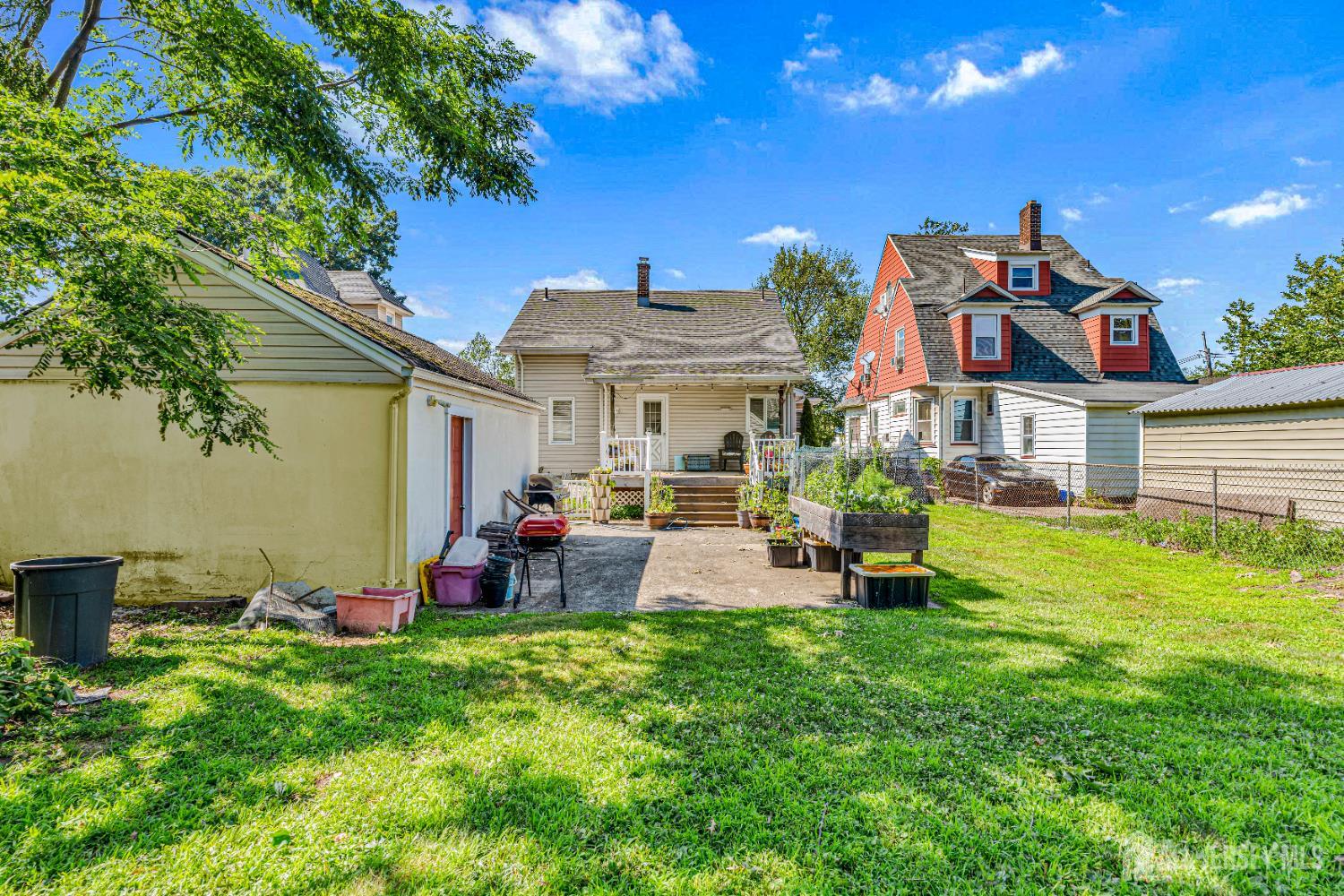 305 Penfield Place Dunellen, NJ 08812 - Photo 37 of 53 a front view of a house with patio and garden