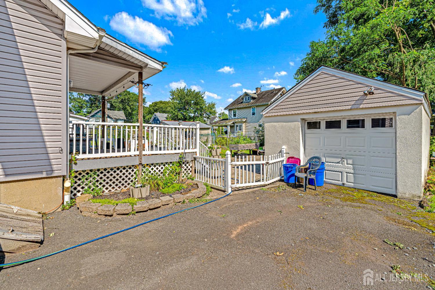 305 Penfield Place Dunellen, NJ 08812 - Photo 39 of 53 a view of a house with a patio and a garden