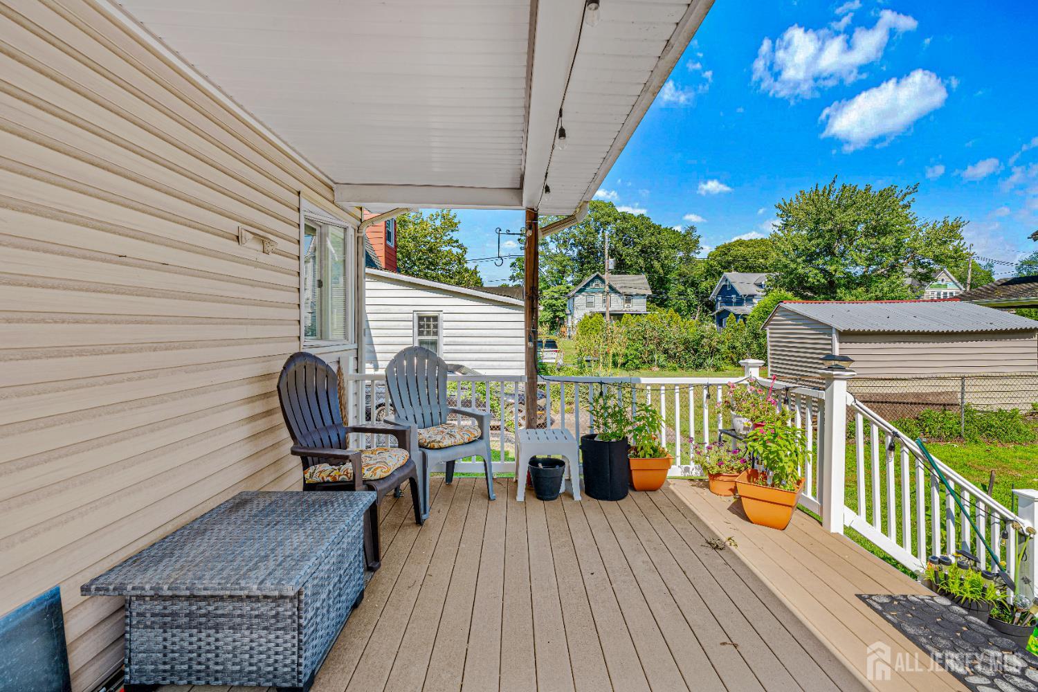 305 Penfield Place Dunellen, NJ 08812 - Photo 4 of 53 a balcony with wooden floor table and chairs