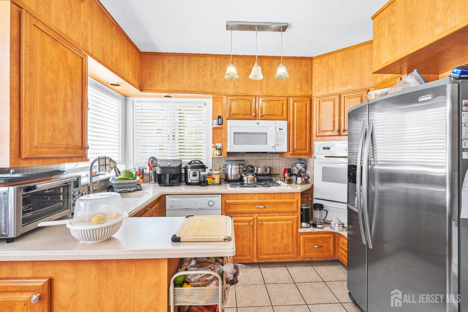 305 Penfield Place Dunellen, NJ 08812 - Photo 10 of 53 a kitchen with stainless steel appliances granite countertop a sink stove and refrigerator