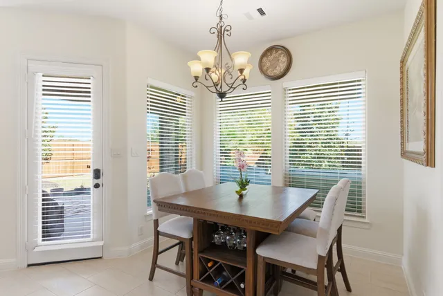 a view of a dining room with furniture and a large window