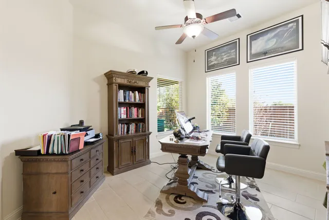 a living room with furniture and a book shelf