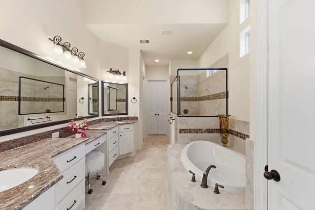 a bathroom with a granite countertop sink mirror and double