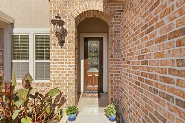 a front view of a house with a garden