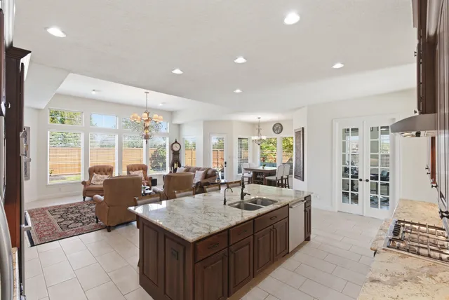 a large kitchen with kitchen island granite countertop a large counter top and sink