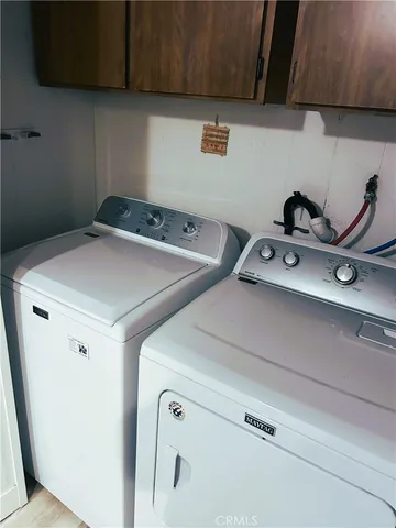a kitchen with granite countertop white cabinets and a sink