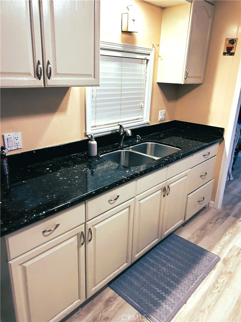 503 Corte Naranja, Unit 503 Rohnert Park, CA 94928 - Photo 14 of 16 a kitchen with granite countertop white cabinets and a sink
