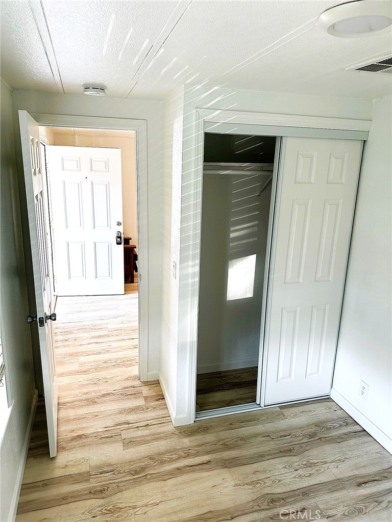 503 Corte Naranja, Unit 503 Rohnert Park, CA 94928 - Photo 6 of 16 a view of a hallway with wooden floor and staircase