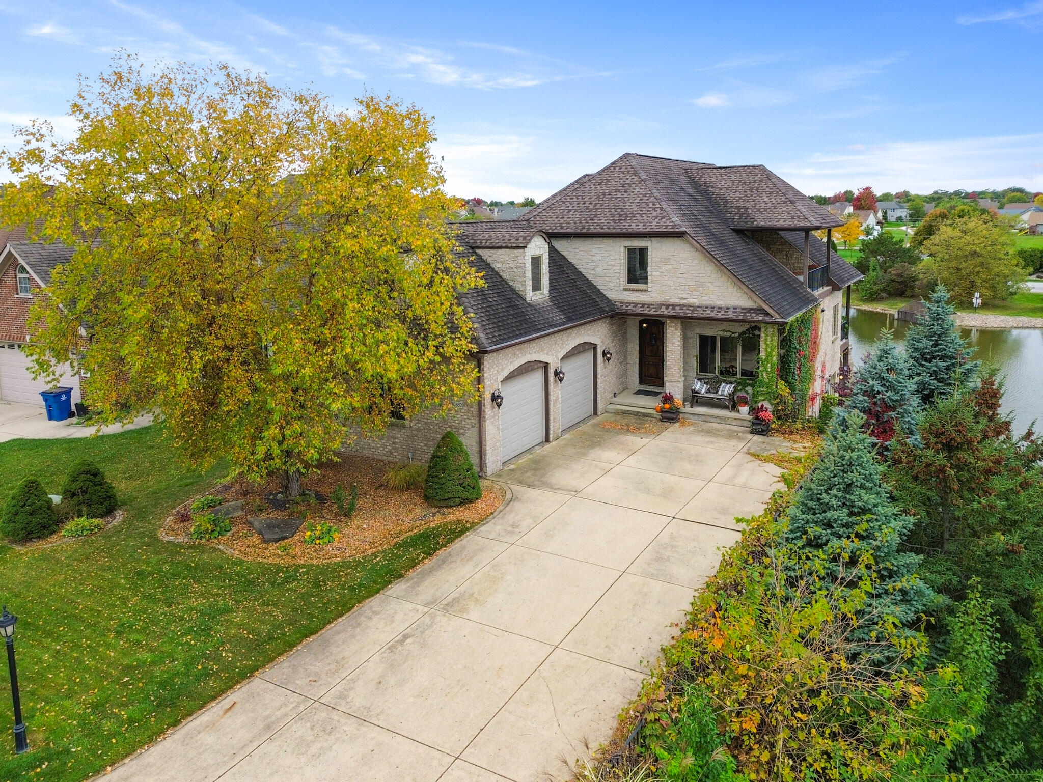 10380 Doubletree Drive South Crown Point, IN 46307 - Photo 76 of 80 a view of a white house with a yard and potted plants