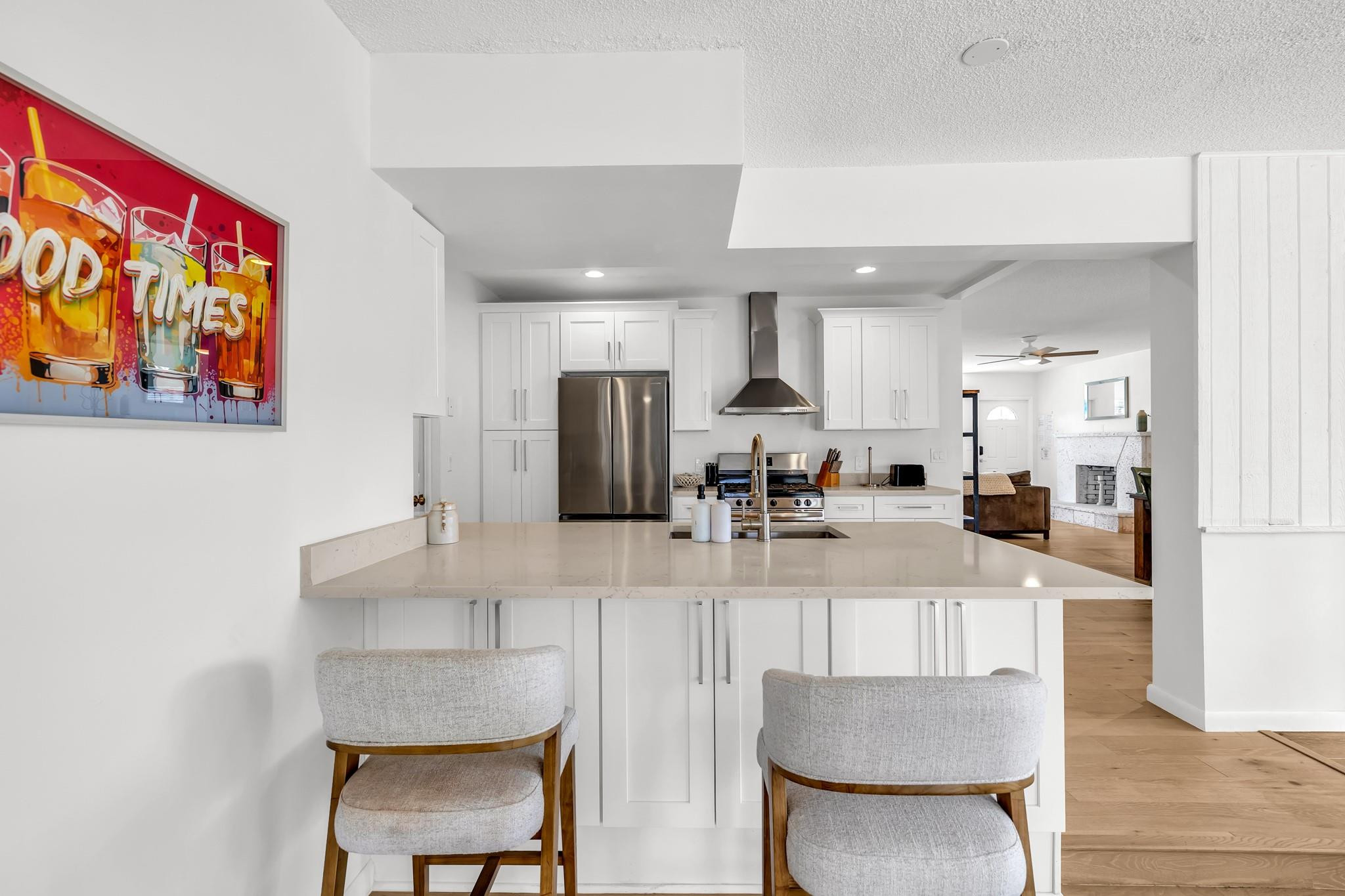5211 Northeast 26th Avenue Lighthouse Point, FL 33064 - Photo 22 of 33 a kitchen with stainless steel appliances a dining table chairs and a refrigerator