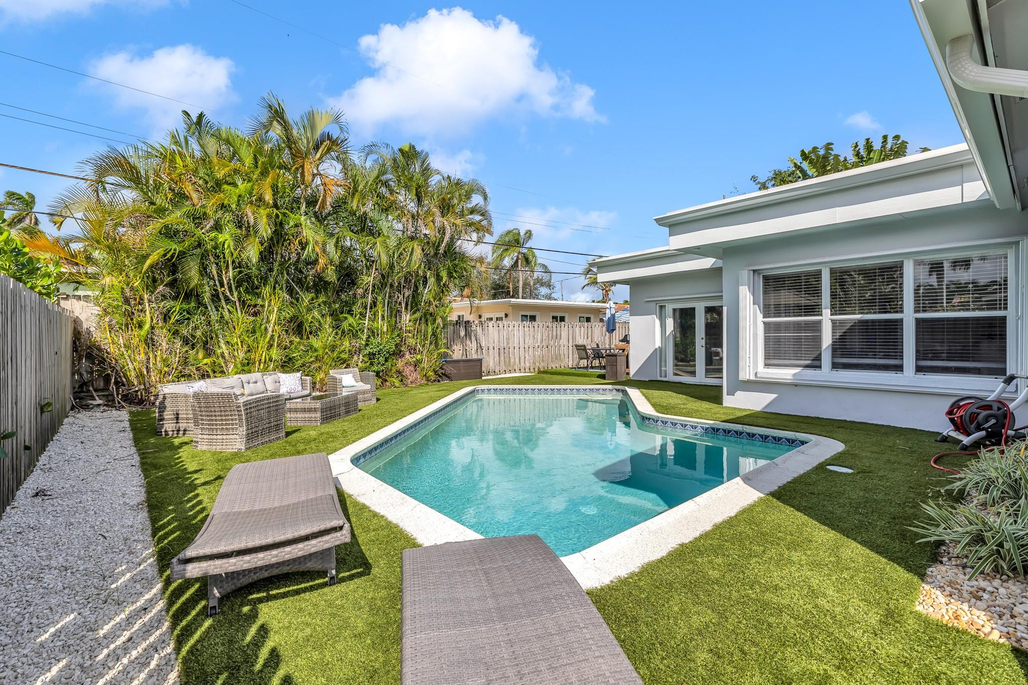 5211 Northeast 26th Avenue Lighthouse Point, FL 33064 - Photo 23 of 33 swimming pool view with a seating space and a garden view