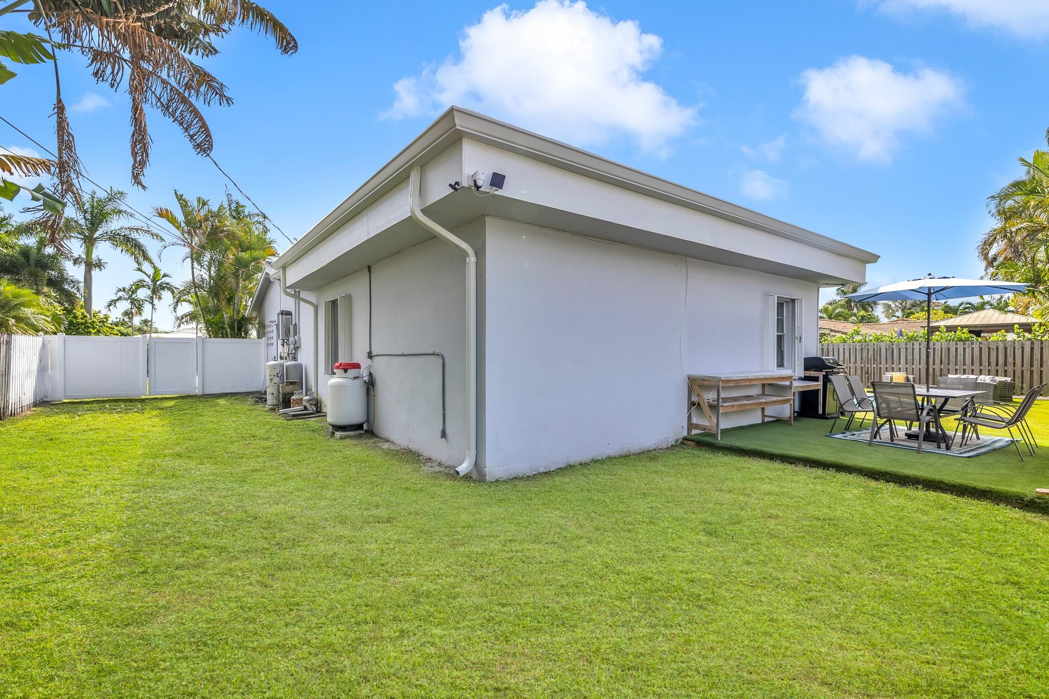 5211 Northeast 26th Avenue Lighthouse Point, FL 33064 - Photo 25 of 33 a view of a backyard with a small cabin and wooden fence