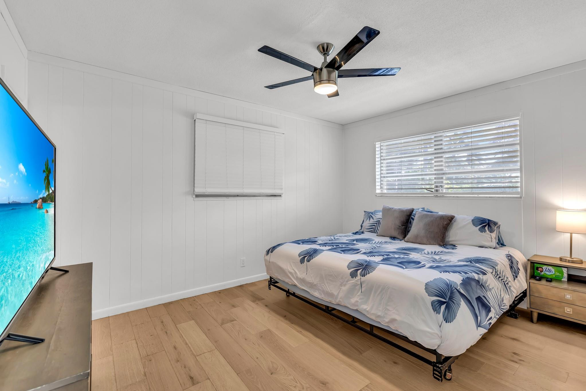 5211 Northeast 26th Avenue Lighthouse Point, FL 33064 - Photo 27 of 33 a bedroom with a bed a window and a potted plant
