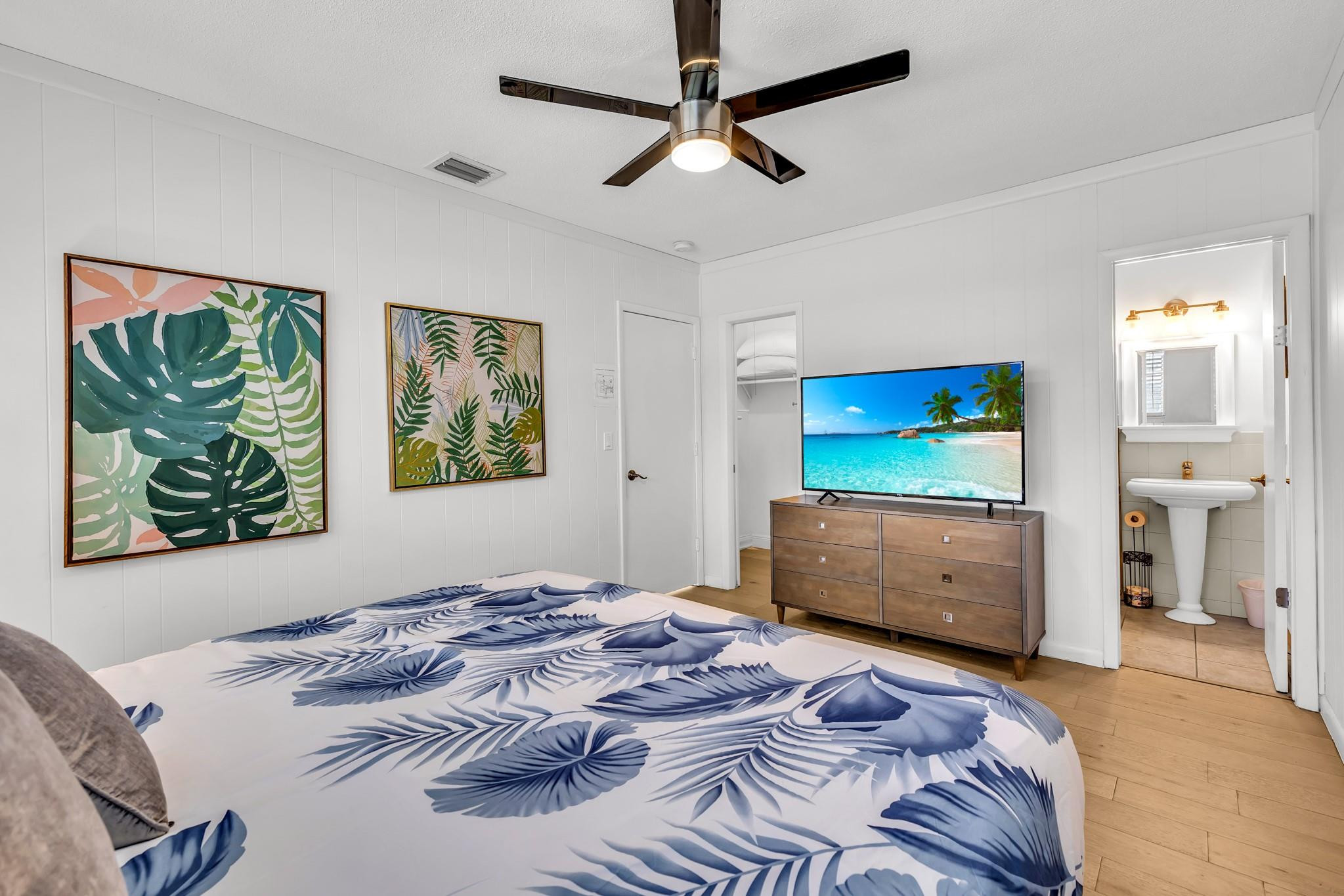 5211 Northeast 26th Avenue Lighthouse Point, FL 33064 - Photo 28 of 33 a bedroom with a bed and a flat screen tv
