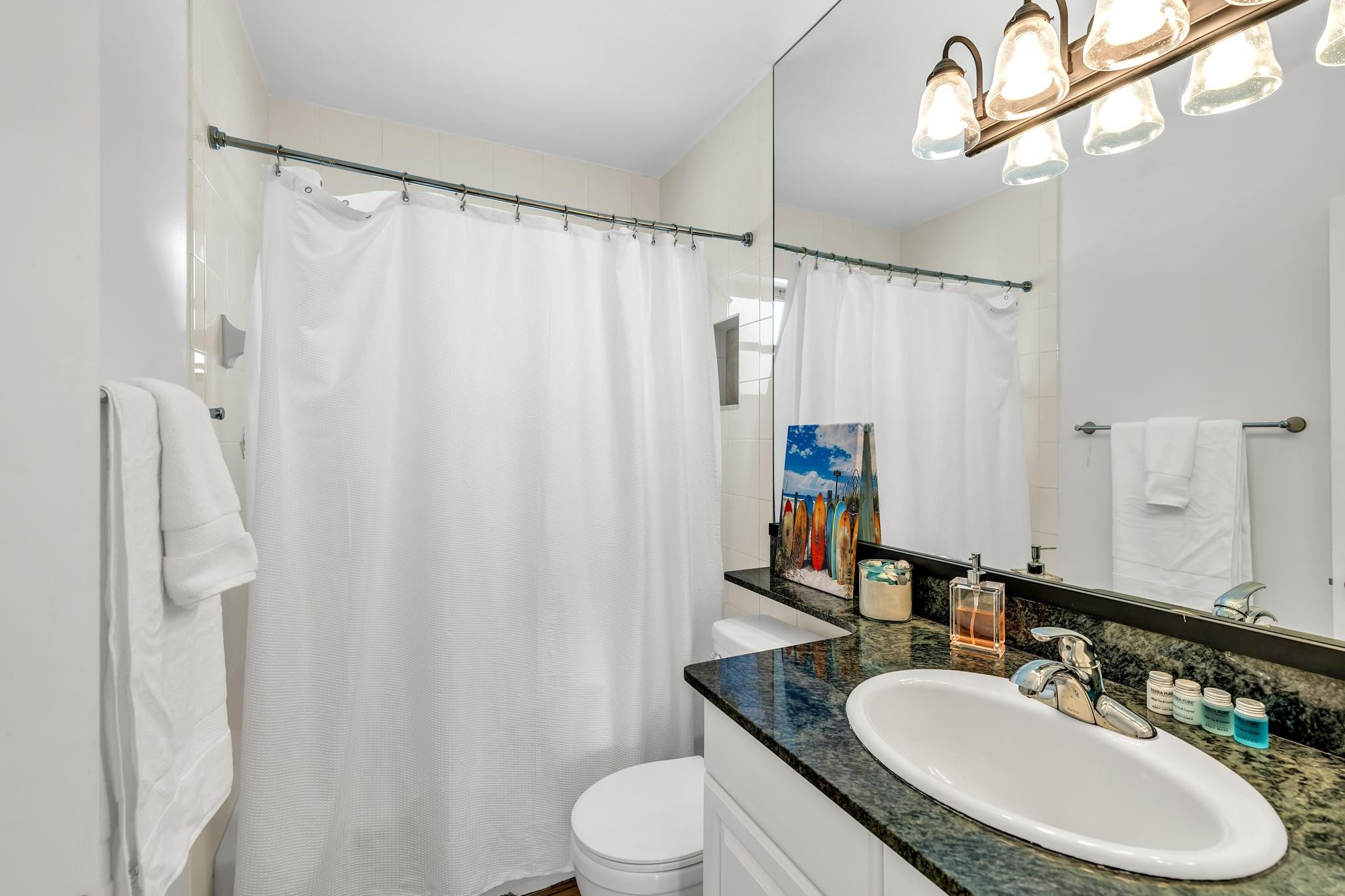 5211 Northeast 26th Avenue Lighthouse Point, FL 33064 - Photo 31 of 33 a bathroom with a sink vanity mirror and toilet