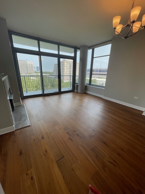 1600 South Prairie Avenue, Unit 904 Chicago, IL 60616 - Photo 5 of 19 wooden floor in an empty room with a window