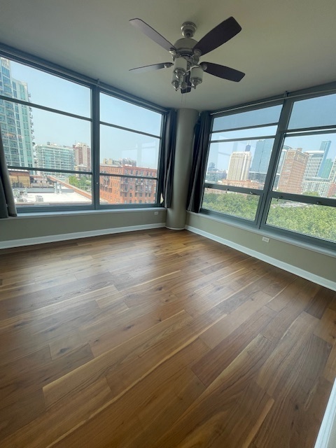 1600 South Prairie Avenue, Unit 904 Chicago, IL 60616 - Photo 7 of 19 an empty room with wooden floor and windows