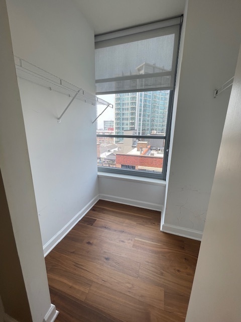 1600 South Prairie Avenue, Unit 904 Chicago, IL 60616 - Photo 10 of 19 a view of an empty room with wooden floor and a window
