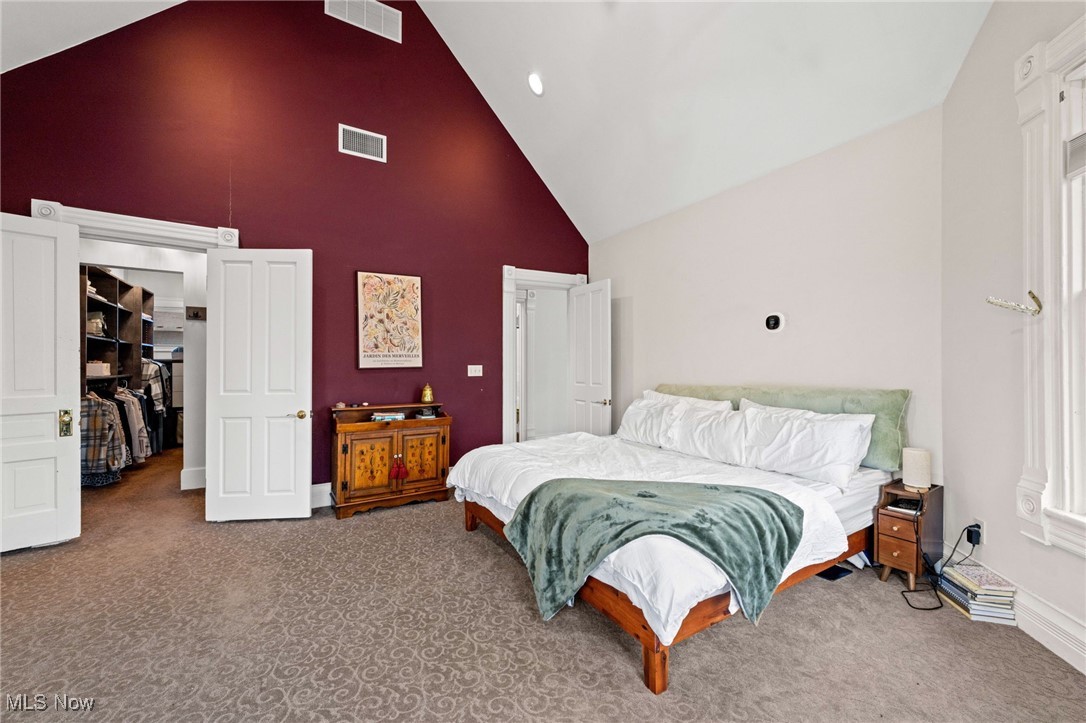 3210 Scranton Road Cleveland, OH 44109 - Photo 24 of 50 Primary bedroom featuring high vaulted ceiling, baseboards, carpet flooring, and visible vents