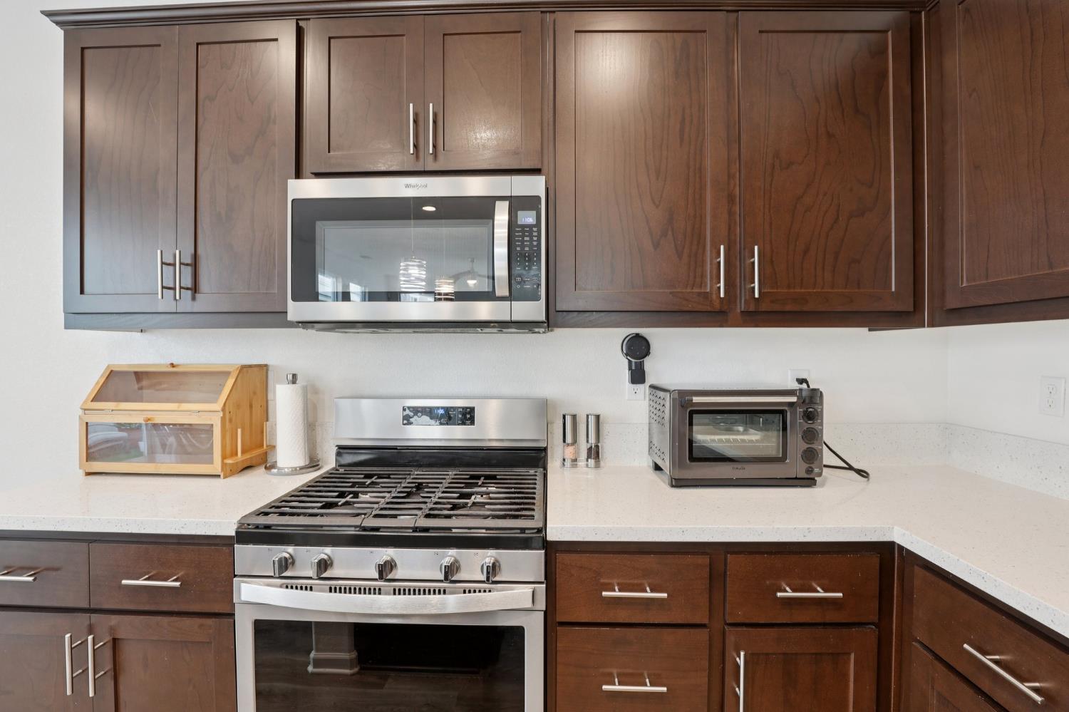 2413 Seaside Road Lathrop, CA 95330 - Photo 11 of 37 a stove top oven sitting inside of a kitchen
