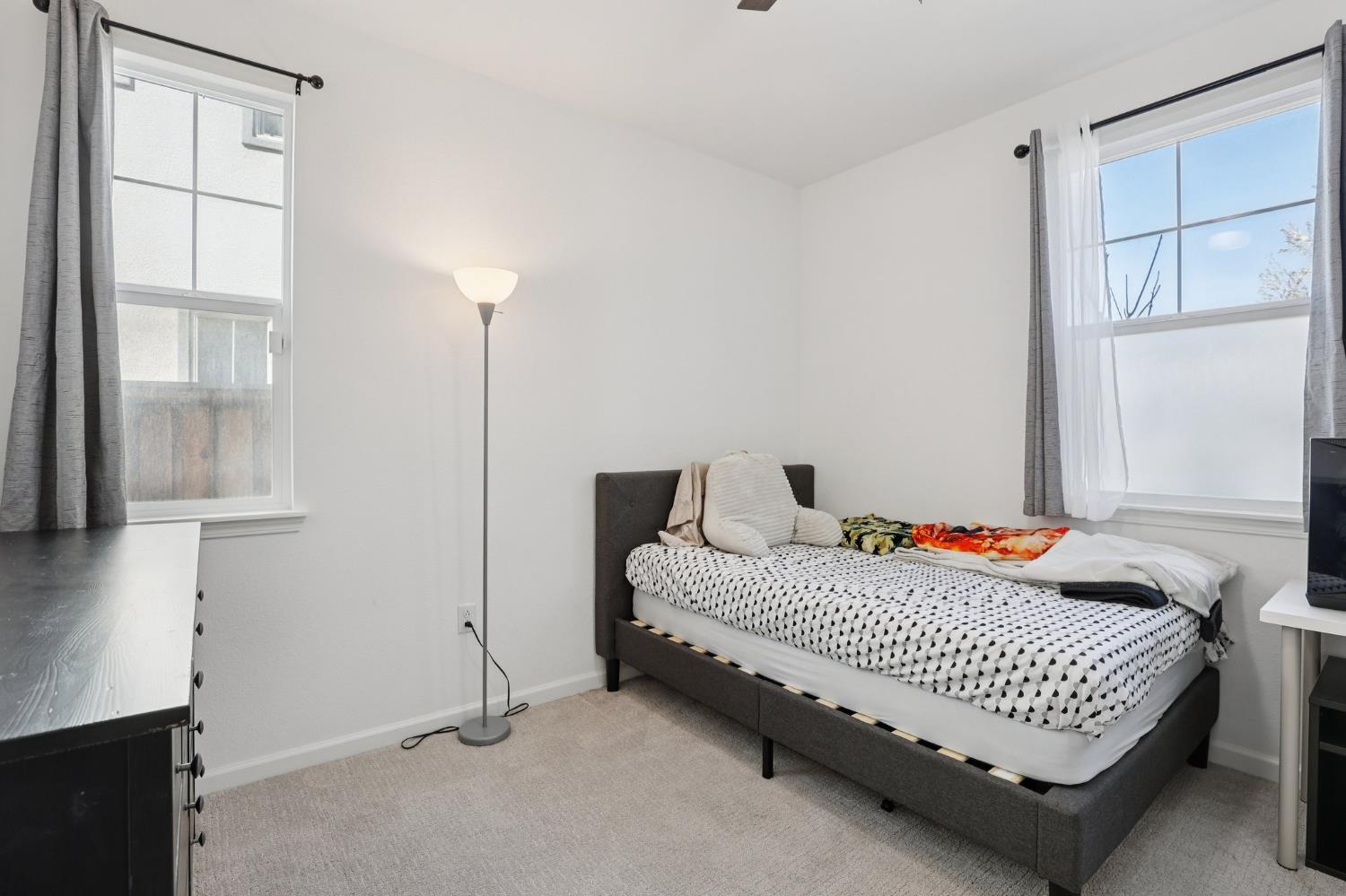 2413 Seaside Road Lathrop, CA 95330 - Photo 17 of 37 a bedroom with a bed and a window