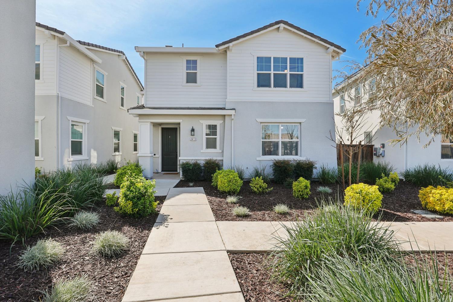 2413 Seaside Road Lathrop, CA 95330 - Photo 2 of 37 a front view of a house with garden